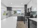 Modern kitchen with white countertops, gray cabinets, and stainless steel appliances at 430 N Omaha St, Lake Hamilton, FL 33851
