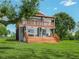 Two-story house with a wooden deck and stairs at 430 N Omaha St, Lake Hamilton, FL 33851