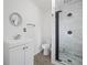 Bathroom with white vanity, toilet and a marble walk-in shower at 430 N Omaha St, Lake Hamilton, FL 33851