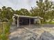 House with carport, patio furniture, and fenced yard at 3511 Avenue R Nw, Winter Haven, FL 33881
