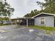 Front view of a house with a carport, and a small front yard at 3511 Avenue R Nw, Winter Haven, FL 33881