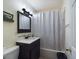 Clean bathroom with shower/tub combo, vanity, and mirror at 3511 Avenue R Nw, Winter Haven, FL 33881