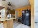 Kitchen area with a refrigerator, and additional counter space at 3511 Avenue R Nw, Winter Haven, FL 33881