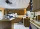 Kitchen with wood cabinets, an island, and a black refrigerator at 3511 Avenue R Nw, Winter Haven, FL 33881