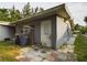 Gray storage shed with a white door and small patio at 3511 Avenue R Nw, Winter Haven, FL 33881