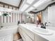 Double vanity bathroom with a bathtub and shower at 209 Santa Rosa Dr, Winter Haven, FL 33884