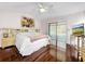Main bedroom with pool view, hardwood floors, and ceiling fan at 209 Santa Rosa Dr, Winter Haven, FL 33884