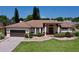 Single-story home with a two-car garage and manicured lawn at 209 Santa Rosa Dr, Winter Haven, FL 33884