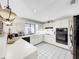 L-shaped kitchen with white cabinets and stainless steel appliances at 209 Santa Rosa Dr, Winter Haven, FL 33884