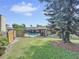 Inviting backyard oasis featuring a screened-in pool and lush landscaping at 209 Santa Rosa Dr, Winter Haven, FL 33884