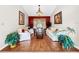 Living room with hardwood floors, white furniture, and a red accent wall at 209 Santa Rosa Dr, Winter Haven, FL 33884
