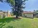 Spacious backyard with lush lawn and mature trees at 209 Santa Rosa Dr, Winter Haven, FL 33884