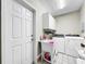 Convenient laundry room with washer, dryer, and utility sink at 209 Santa Rosa Dr, Winter Haven, FL 33884