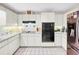 Kitchen with white cabinets, stainless steel appliances, and tile floors at 209 Santa Rosa Dr, Winter Haven, FL 33884