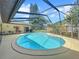 Screened-in kidney-shaped pool and spacious patio area at 209 Santa Rosa Dr, Winter Haven, FL 33884