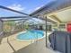 Large kidney-shaped pool with a screened enclosure and patio at 209 Santa Rosa Dr, Winter Haven, FL 33884