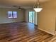 Spacious living room with wood-look floors and sliding glass doors at 1039 Medinah Dr, Winter Haven, FL 33884