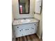 Bathroom with granite vanity and updated flooring at 1039 Medinah Dr, Winter Haven, FL 33884