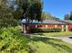 Condo exterior with red fence and landscaping at 1039 Medinah Dr, Winter Haven, FL 33884