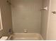 Beige tiled bathroom with shower and bathtub at 1039 Medinah Dr, Winter Haven, FL 33884