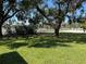 View of tennis courts from a grassy area at 1039 Medinah Dr, Winter Haven, FL 33884