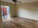 Bright bedroom with wood-look flooring and sliding glass doors to patio at 1039 Medinah Dr, Winter Haven, FL 33884
