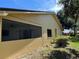 Rear exterior of house with screened porch and landscaping at 1039 Medinah Dr, Winter Haven, FL 33884