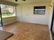 Screened porch with tiled floor and access door at 1039 Medinah Dr, Winter Haven, FL 33884