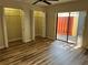 Bedroom with double closets and wood-look flooring, plus patio access at 1039 Medinah Dr, Winter Haven, FL 33884