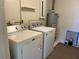 Laundry room with washer, dryer, and water heater at 1039 Medinah Dr, Winter Haven, FL 33884