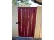 Red wooden gate providing access to backyard at 1039 Medinah Dr, Winter Haven, FL 33884