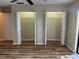 Spacious bedroom with double closets and wood-look flooring at 1039 Medinah Dr, Winter Haven, FL 33884