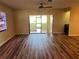 Living room with wood-look floors and sliding glass doors at 1039 Medinah Dr, Winter Haven, FL 33884