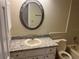 Bathroom with granite vanity, oval mirror, and bathtub at 1039 Medinah Dr, Winter Haven, FL 33884