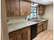 Kitchen with wood cabinets and granite countertops at 1039 Medinah Dr, Winter Haven, FL 33884