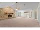 Open living room featuring a large stone fireplace and high ceilings at 222 Okaloosa Dr, Winter Haven, FL 33884