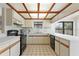 Galley kitchen with wood beams and ample counter space at 222 Okaloosa Dr, Winter Haven, FL 33884