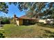 Spacious backyard with mature trees and a large grassy area at 222 Okaloosa Dr, Winter Haven, FL 33884