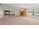 Living area showcasing a stone fireplace and access to a sunroom at 222 Okaloosa Dr, Winter Haven, FL 33884