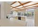 Open kitchen with breakfast bar and wood-beam ceiling at 222 Okaloosa Dr, Winter Haven, FL 33884
