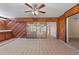 Sunroom with wood paneling, tile flooring, and sliding glass doors at 222 Okaloosa Dr, Winter Haven, FL 33884