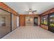 Sunroom with wood walls, tile floor, and access to the backyard at 222 Okaloosa Dr, Winter Haven, FL 33884