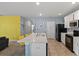 Modern kitchen with white cabinets, quartz countertops and yellow barstools at 2304 Rose Blvd, Winter Haven, FL 33881