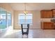 Breakfast nook with glass-top table and chandelier, adjacent to kitchen at 1274 Zambrana Ct, Winter Haven, FL 33884