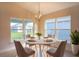 Bright dining area with a round table and grey chairs near the kitchen at 1274 Zambrana Ct, Winter Haven, FL 33884