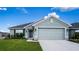 One-story house with light green exterior and two-car garage at 1274 Zambrana Ct, Winter Haven, FL 33884