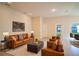 Spacious living room featuring a brown leather sofa and armchairs at 1274 Zambrana Ct, Winter Haven, FL 33884