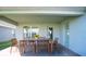 Covered patio with wooden dining table and chairs, perfect for outdoor dining at 1274 Zambrana Ct, Winter Haven, FL 33884