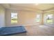 Spacious bedroom with neutral walls and carpet, featuring three windows offering ample natural light at 1274 Zambrana Ct, Winter Haven, FL 33884