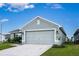 One-story house with a two-car garage and landscaping at 1274 Zambrana Ct, Winter Haven, FL 33884